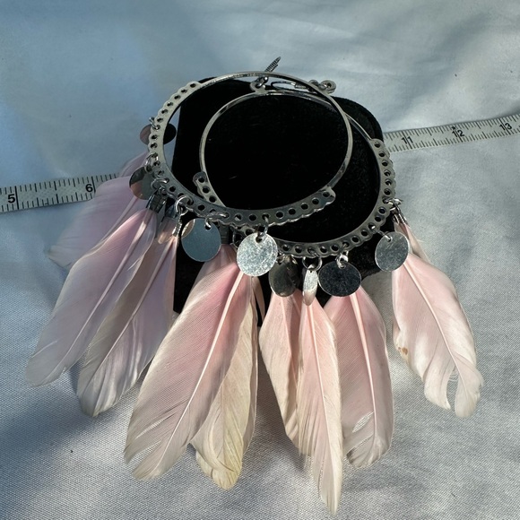 Large silvertone hoop earrings with light pink feathers - Picture 4 of 5
